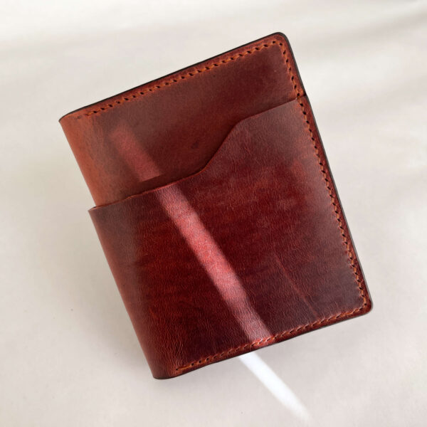 Brown leather wallet view from front side, folded.