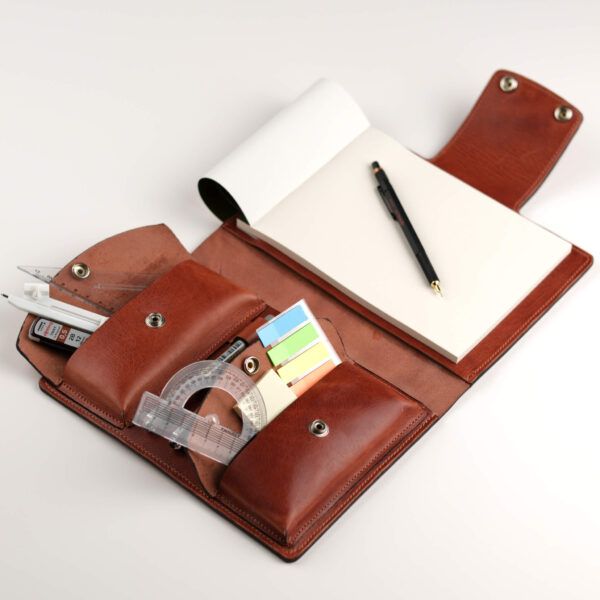 a leather journal for A5 notebooks or sketchbooks with three pen loops and two large pockets for tools and gadgets.