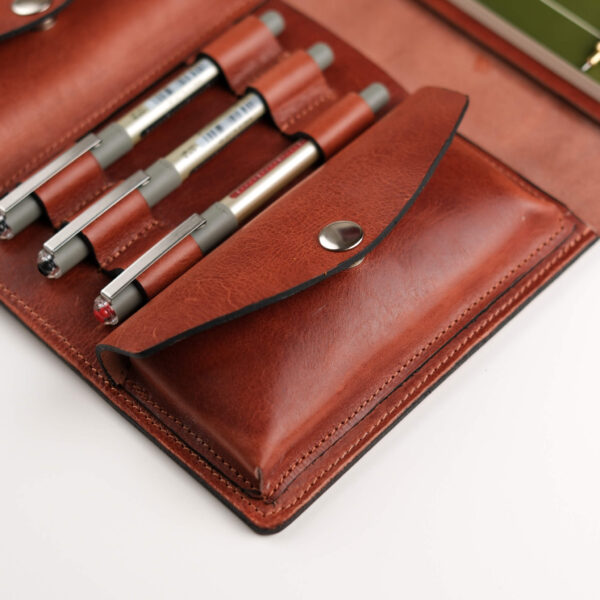 a leather journal for A5 notebooks or sketchbooks with three pen loops and two large pockets for tools and gadgets.